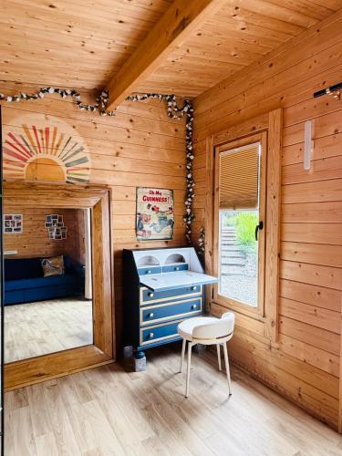 a room with a desk and a chair in a wooden room at Riverside Garden B and B in Bishops Village