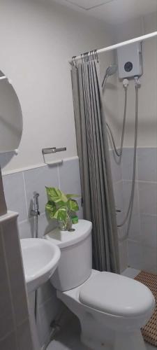 a bathroom with a toilet and a sink at Studio Type Furnished Condo in Lapu Lapu City