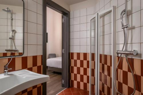 a bathroom with a sink and a shower at BYPILLOW Grand Central in Padova