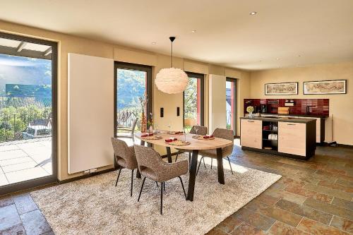a kitchen and dining room with a table and chairs at Wohnen am Weingut - Über den Fässern in Briedel