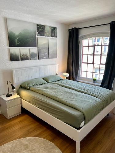a bedroom with a large bed and a window at Apartment Altstadt Stralsund in Stralsund