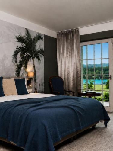 a bedroom with a bed and a large window at Hotel Villa Rainer in Pörtschach am Wörthersee