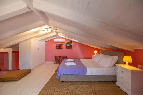 a bedroom with a large bed in an attic at Villa Kirki Apartments in Agia Effimia
