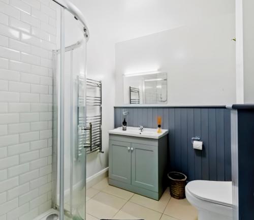 a bathroom with a sink and a shower at Riverside Garden B and B in Bishops Village