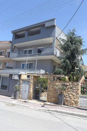 a building on the side of a street at Villa Joanna Seasides , Top Floor in Mesimérion
