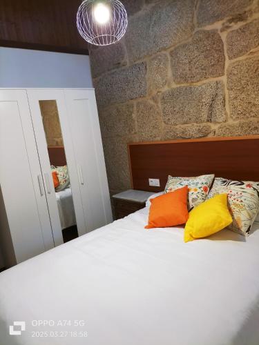 a bedroom with a bed with two pillows on it at Muiño Verde in Loña del Monte
