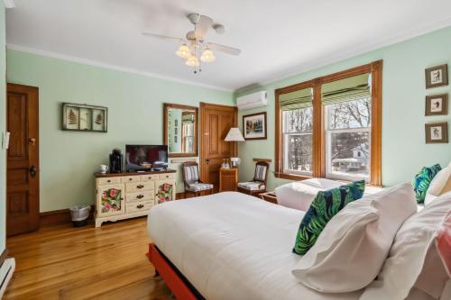 a bedroom with two beds and a television at Alicion Bed & Breakfast in Lunenburg