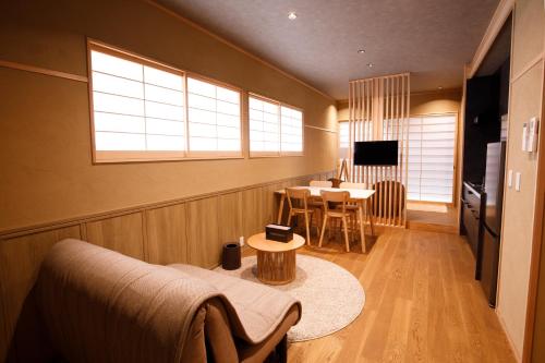 a living room with a couch and a table at Shiosai HIRADO in Hirado