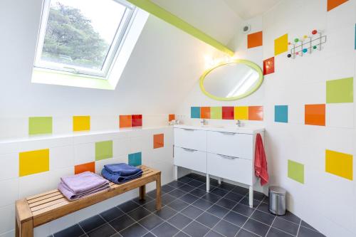 a bathroom with a sink and a mirror at Domaine de Kerroux in Bannalec