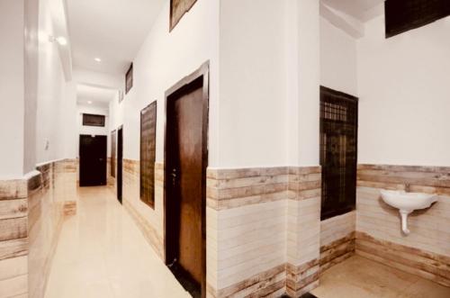 a hallway with a bathroom with a sink on the wall at Hotel HP Palace in Gorakhpur