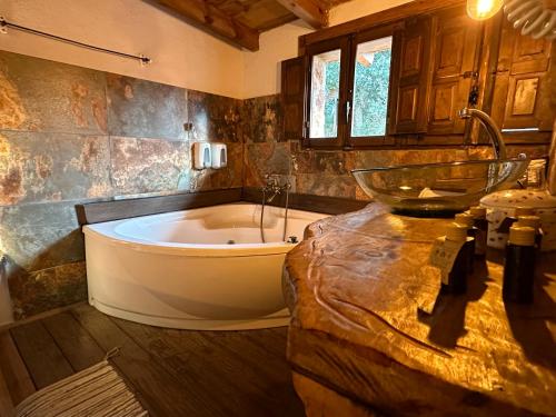 a large bathroom with a tub and a sink at Xalet De Prades in Prades