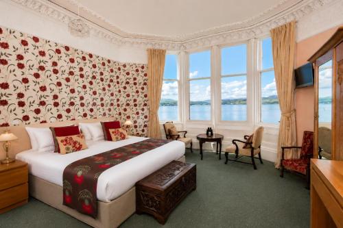 a hotel room with a bed and a large window at The Ardyne Guest House in Rothesay