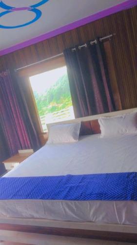 a large bed in a room with a window at Celestia peaks in Bhowāli
