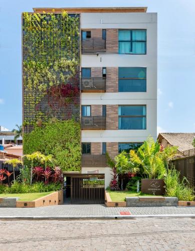 a building with plants on the side of it at Praça Cinco in Porto De Galinhas