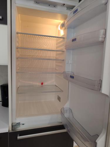 an empty refrigerator with its door open at Blue bay Sliema in Sliema