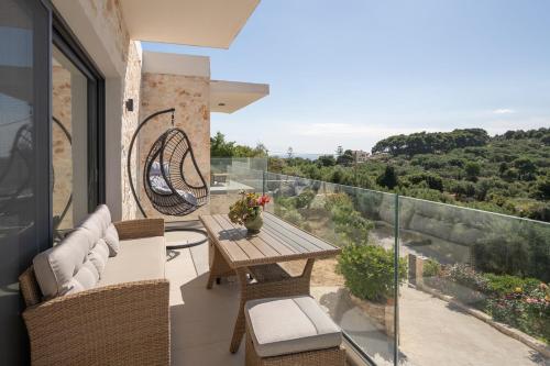 a patio with a wooden table and chairs on a balcony at Villa Mimoza Apelati in Keri
