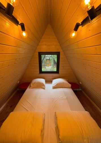 a bedroom with two beds in a small room at Strefa Czasu Skorzęcin in Skorzęcin
