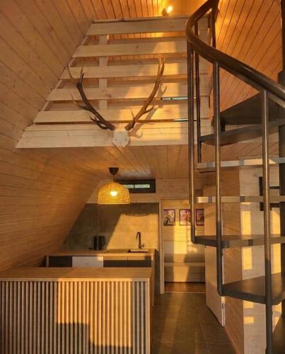a kitchen with a ceiling fan and a staircase at Strefa Czasu Skorzęcin in Skorzęcin