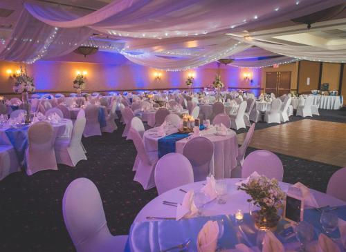 a banquet hall with white tables and purple chairs at The Inn on Lake Superior in Duluth
