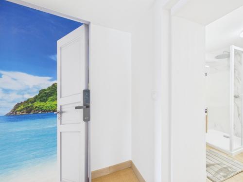 an open door to the beach at Arden Suites Hébergements à thème in Charleville-Mézières