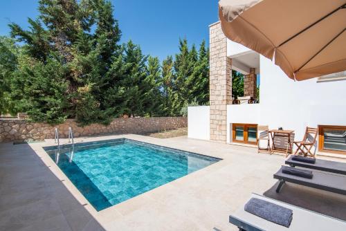 a swimming pool in the backyard of a house at Katrin Aegina in Egina