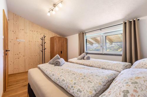 a bedroom with two beds and a window at Ferienwohnung Grubgut in Taxenbach