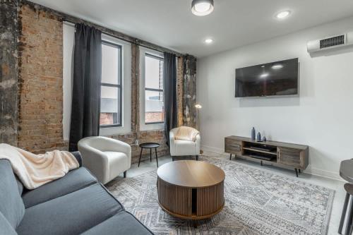 a living room with a couch and a table at Park Hotel 2BR Suite 306 in Chattanooga