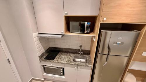 a small kitchen with a sink and a refrigerator at Today Perdizes São Paulo - Allianz Parque in São Paulo