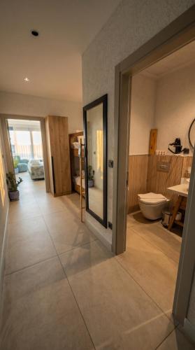 a large bathroom with a toilet and a sink at Taga Hotel in Bitez