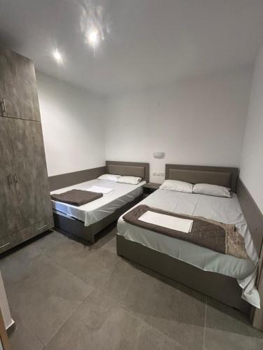 a bedroom with two beds in a room at Priona Rooms in Paralía Skotínis