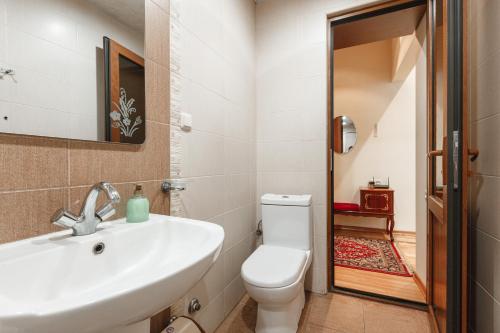 a bathroom with a white sink and a toilet at Large apartment by the Opera- luxury living room, 2 bedrooms, equipped kitchen and balcony in Yerevan
