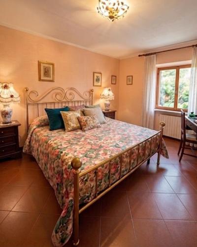 a bedroom with a bed and two tables and a window at Casa Corbella in Magnano