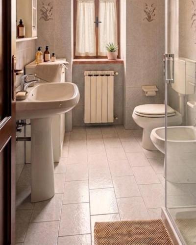 a bathroom with a sink and a toilet and a shower at Casa Corbella in Magnano
