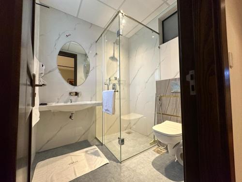 a bathroom with a shower and a sink and a toilet at Tower 92 - Hotel in Ghora
