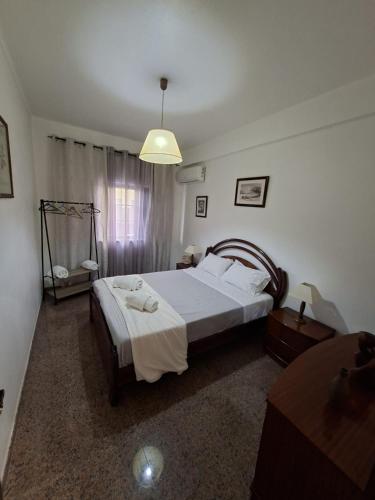 a bedroom with a large bed and a lamp at Constança House in Corroios