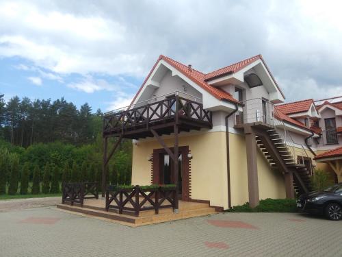 a house with a balcony on top of it at Biovilla in Stobnicko