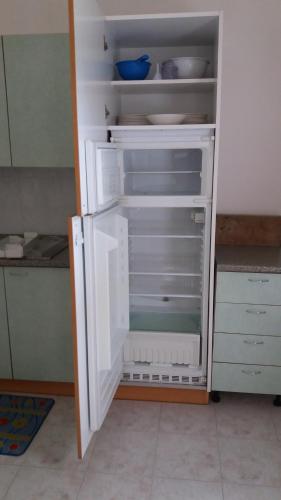 a white refrigerator with its door open in a kitchen at Dreon B&B in Portogruaro