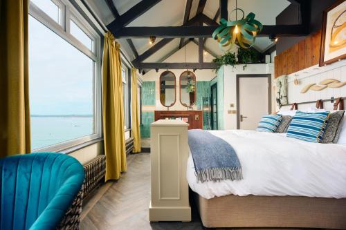 a bedroom with a bed and a large window at Pedn-Olva in St Ives