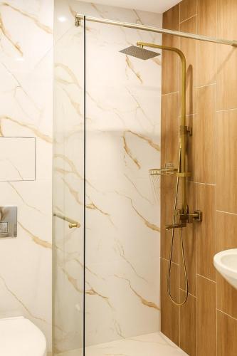 a shower with a glass door in a bathroom at Panorama Sunset Studio in Stara Zagora
