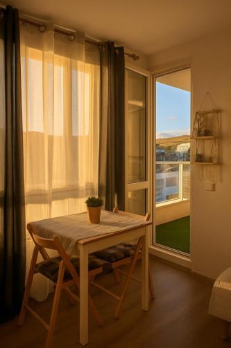 a room with a table and a large window at Panorama Sunset Studio in Stara Zagora