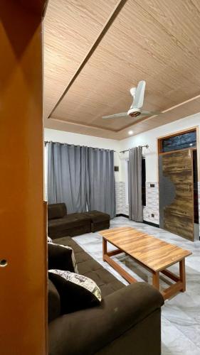 a living room with a couch and a table at 1 Bed Apartment with View in Patriata