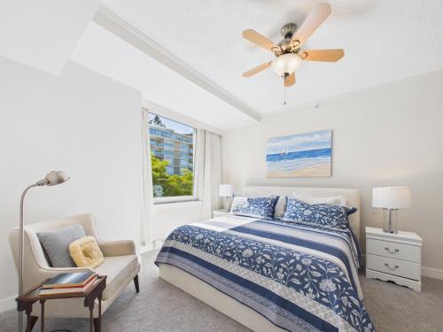 a bedroom with a bed and a ceiling fan at Panoramic Ocean & Fairway Views At Sayward Hill in Victoria