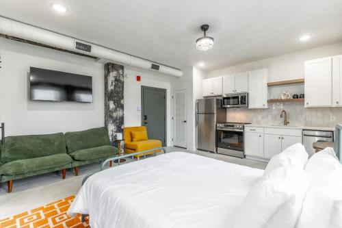 a bedroom with a white bed and a kitchen at Park Hotel Studio Suite 507 in Chattanooga