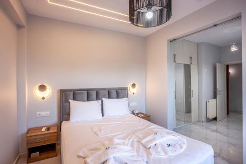 a bedroom with a bed and a large mirror at Villa Olia with private pool in Pefkochori