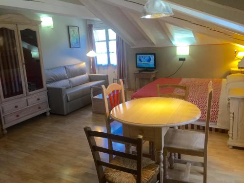 a living room with a table and chairs and a couch at Apartamentos Alquitara in Potes