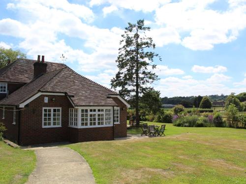 a small brick house with a picnic table in a yard at Castle House Cottage in Horton