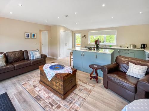 a living room with a couch and a table at Ridge View Lodge - Uk49924 in Dumfries
