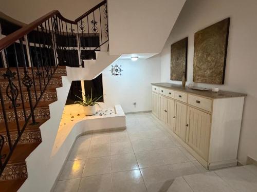 a staircase in a room with a stair case at villa la dueña in San Felipe de Puerto Plata