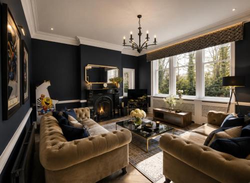 a living room with couches and a fireplace at Chowdene Lodge Estate in Gateshead