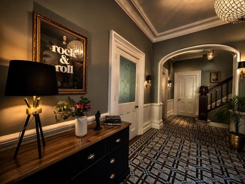 a living room with a dresser and a hallway at Chowdene Lodge Estate in Gateshead